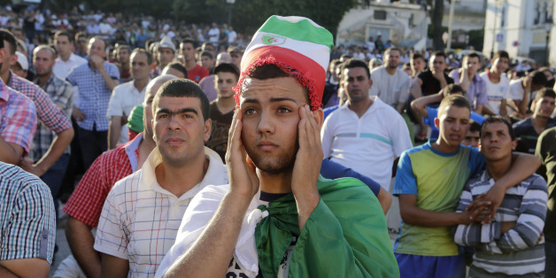 Algerian fans react while watch their team play Belgium during their 2014 World Cup Group H soccer match at a public screening event in Algiers June 17, 2014. REUTERS/Louafi Larbi (ALGERIA - Tags: SPORT SOCCER WORLD CUP)