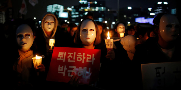 People march toward the Presidential Blue House during a rally calling for President Park Geun-hye to step down in central Seoul, South Korea, November 12, 2016. The sign reads: "Step down Park Geun-hye." REUTERS/Kim Hong-Ji TPX IMAGES OF THE DAY