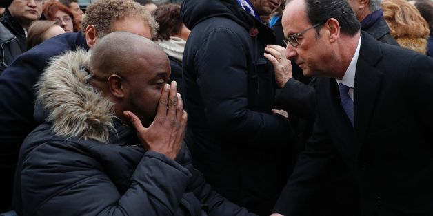 French President Francois Hollande (R) speaks with a victim after unveiling a commemorative plaque outside the Stade de France stadium, in Saint-Denis, north of Paris, on November 13, 2016, during a ceremony to mark the first anniversary of the Paris terror attacks.
130 people were killed on November 13, 2015 by gunmen and suicide bombers from the Islamic State (IS) group in a series of coordinated attacks in and around Paris. / AFP / POOL / PHILIPPE WOJAZER (Photo credit should read PHILIPPE WOJAZER/AFP/Getty Images)