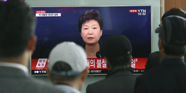 FILE - In this Friday, Nov. 4, 2016 file photo, people watch a TV screen showing the live broadcast of South Korean President Park Geun-hye's address to the nation on a "heartbreaking" scandal, at the Seoul Railway Station in Seoul. South Korean prosecutors are likely to question Park over suspicion that she let a shadowy longtime confidante manipulate power from behind the scenes, state-run Yonhap news agency reported Sunday, Nov. 13. (AP Photo/Lee Jin-man, File)