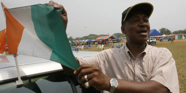 Former Ivory Coast soccer player Laurent Pokou holds the Ivory Coast national flag during an interview in Sekondi, Ghana, January 27, 2008. Pokou, whose African Nations Cup goalscoring record has been equalled by Cameroon striker Samuel Eto'o, called compatriot Didier Drogba a true patriot on Sunday. REUTERS/Luc Gnago (GHANA)