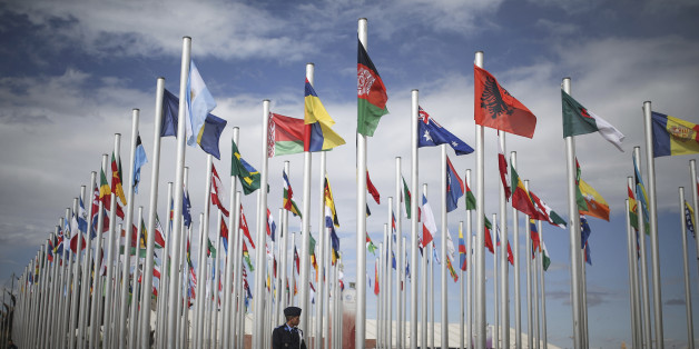 A member of Moroccan security stands guard next to flags of participating UN member states, on the entrance to the COP22 village, a day ahead of the opening ceremony, in Marrakesh, Morocco, Sunday, Nov. 6, 2016. The Climate Conference, known as the COP22, starts Monday in Marrakech. (AP Photo/Mosa'ab Elshamy)