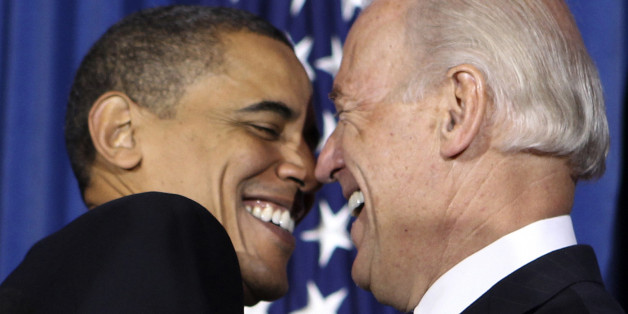 U.S. President Barack Obama (L) and Vice President Joseph Biden attend a rally celebrating the passage and signing into law of the Patient Protection and Affordable Care Act health insurance reform bill while at the Interior Department in Washington March 23, 2010. REUTERS/Larry Downing (UNITED STATES - Tags: POLITICS)