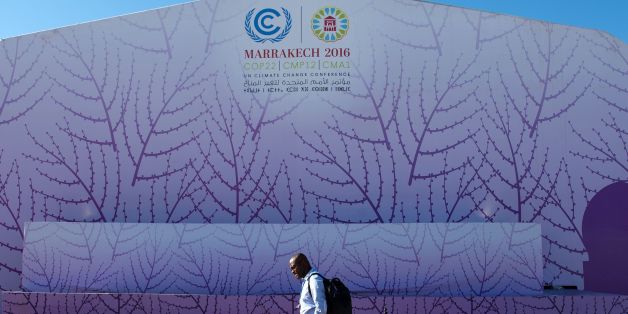 A man walks past the logo of the COP22 international climate conference on November 9, 2016, in Marrakesh. / AFP / FADEL SENNA (Photo credit should read FADEL SENNA/AFP/Getty Images)