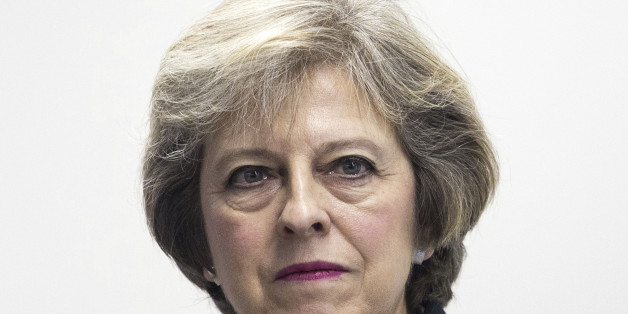 British Prime Minister Theresa May, reacts during a visit to Diabetes UK, where she opened their new charity headquarters in east London, Monday Nov. 14, 2016. Britain will be a "global champion of free trade," according to details of a speech by Prime Minister Theresa May released Monday, acknowledging that the U.S. election of Donald Trump and the U.K. vote to leave the European Union mark an era of profound world change. (Jack Taylor / PA via AP)