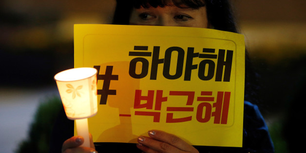 A woman attends a protest denouncing President Park Geun-hye over a recent influence-peddling scandal in central Seoul, South Korea, October 27, 2016. The banner reads "Call for Park Geun-hye to step down". REUTERS/Kim Hong-Ji