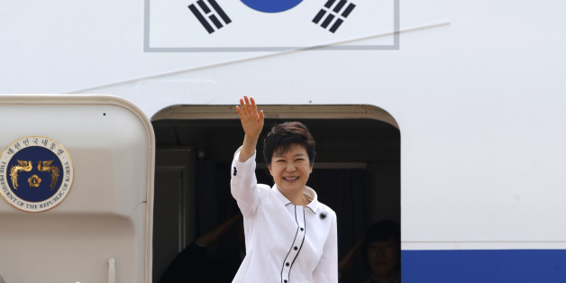 South Korean President Park Geun-hye waves as she embarks an airplane at the Seoul Air Base of South Korean air force in Seongnam, south of Seoul June 27, 2013, before she leaves for China. Park will arrive in Beijing on Thursday for her four-day state visit and will hold her first summit with Chinese President Xi Jinping. REUTERS/Lee Jae-Won (SOUTH KOREA - Tags: POLITICS)