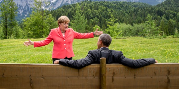 Germany's Chancellor Angela Merkel (L) gestures while chatting with US President Barack Obama sitting on a bench outside the Elmau Castle after a working session of a G7 summit near Garmisch-Partenkirchen, southern Germany, on June 8, 2015. AFP PHOTO / POOL / MICHAEL KAPPELER / AFP / POOL / MICHAEL KAPPELER (Photo credit should read MICHAEL KAPPELER/AFP/Getty Images)