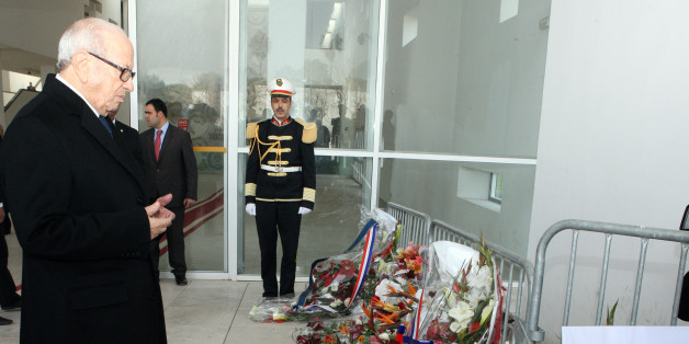 Tunisian's president Beji Caid Essebsi, left, lays a wreath in memory of the victims of the terrorist attack at the Bardo Museum in Tunis, Sunday March 22, 2015. The two extremist gunmen who killed 21 people at a museum in Tunis trained in neighboring Libya before caring out the deadly attack, a top Tunisian security official said. (AP Photo/Ali Louati)