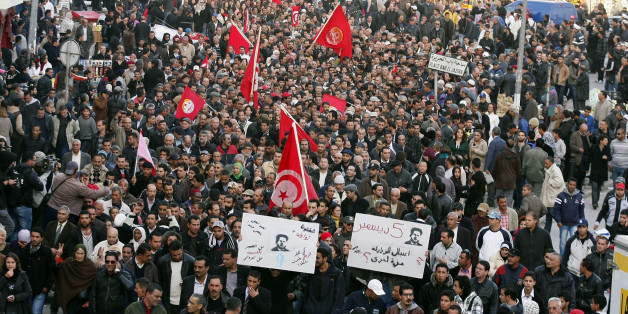 Trade unionists shouts slogans as they rally outside the headquarters of the Union of Tunisian Workers on December 4, 2012 in Tunis. Suspected supporters of Tunisia's ruling Islamist party attacked the demonstration by the country's main trade union the UGTT, which organised a string of anti-government protests last week, and who were demonstrating outside the union's headquarters in Tunis to mark the 60th anniversary of the death of its founder, Farhat Hached. AFP PHOTO / KHALIL (Photo credit should read KHALIL/AFP/Getty Images)