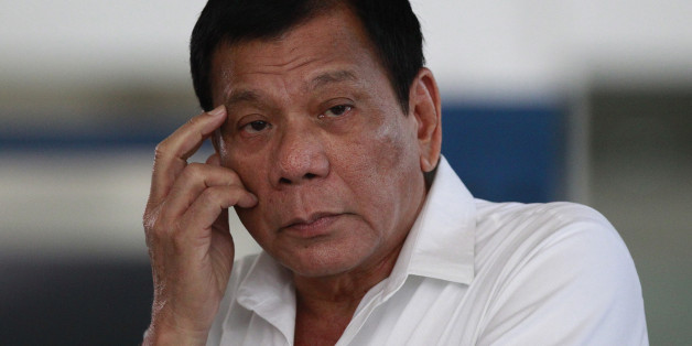 Philippine President Rodrigo Duterte listens to a question from reporters at Manila's International Airport, Philippines on Wednesday, Nov. 9, 2016. Duterte is set to fly to Bangkok to pay his respects to late Thailand's King Bhumibol Adulyadej. He then goes to Malaysia for an official visit. (AP Photo/Aaron Favila)