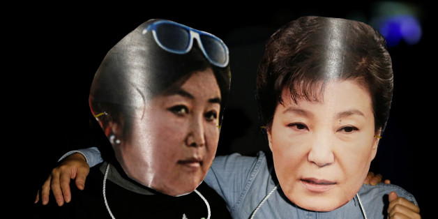 Protesters wearing cut-out of South Korean President Park Geun-hye (R) and Choi Soon-sil attend a protest denouncing President Park Geun-hye over a recent influence-peddling scandal in central Seoul, South Korea, October 27, 2016. REUTERS/Kim Hong-Ji