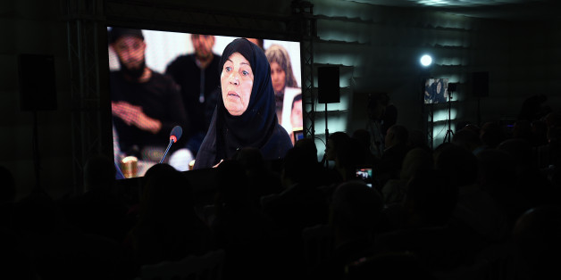 A picture taken on November 17, 2016, in Tunis shows relatives of abuse victims watching a live broadcast of Ourida Kadoussi, the mother of a protester shot by security forces in January 2011 during the uprising that toppled longtime dictator Zine El Abidine Ben Ali, as she delivers her testimonial before the The Truth and Dignity Commission (IVD).
Victims of murder, rape and torture under successive dictatorships started testifying on live television Thursday as Tunisia -- in a rare move for the Arab world -- tries to deal with decades of abuse.
The Truth and Dignity Commission (IVD) has tracked human rights violations committed between July 1955, a year before Tunisia gained its independence from France, and December 2013 when the fact-finding body was established. / AFP / FETHI BELAID (Photo credit should read FETHI BELAID/AFP/Getty Images)