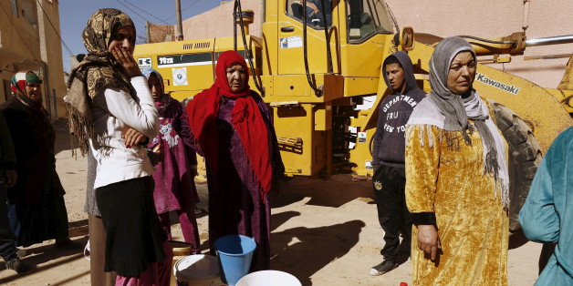 Women queue to fill their buckets with water from a portable tank at the impoverished Karma neighborhood of Kasserine, where young people have been demonstrating for jobs since last week, January 27, 2016. REUTERS/Zohra Bensemra