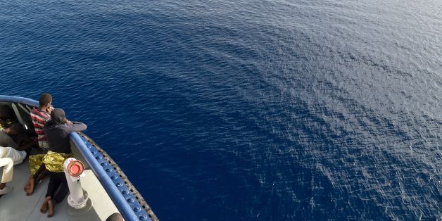 Migrants and refugees wait to arrive in Italy aboard the Topaz Responder ship, run by Maltese NGO Moas and the Red Cross, on November 7, 2016 after a rescue operation off the Libyan coast in the Mediterranean sea. / AFP / ANDREAS SOLARO (Photo credit should read ANDREAS SOLARO/AFP/Getty Images)