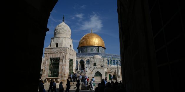 Palestinians walk past the Dome of Rock at the Al-Aqsa Mosque compound after the Friday prayer in Jerusalem's Old City on November 11, 2016. / AFP / AHMAD GHARABLI (Photo credit should read AHMAD GHARABLI/AFP/Getty Images)