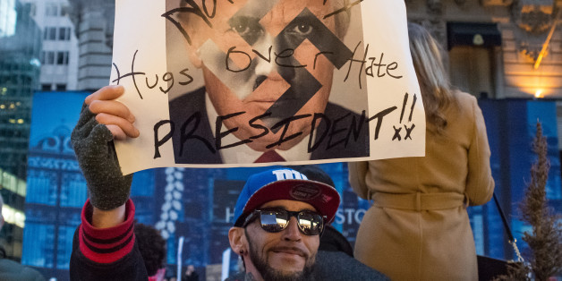 MANHATTAN, NEW YORK, NY, UNITED STATES - 2016/11/12: At the conclusion of a mass rally near Trump Tower, a demonstrator displays a sign. Following a rally on the fourth day after the U.S. Presidential election, several hundred demonstrators took to the streets of midtown Manhattan, staging an unauthorized march through traffic, eventually ending near West 57th Street and Seventh Avenue after passing through Times Square. (Photo by Albin Lohr-Jones/Pacific Press/LightRocket via Getty Images)
