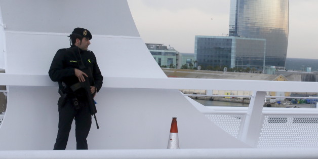 A civil guard keeps watch while restricting public access on a bridge which leads to the cruise ship docks of Barcelona port, where cruise ship MSC Splendida has docked after leaving Tunis March 20, 2015. Tunisia said it would deploy the army to major cities and arrested nine people on Thursday after 20 foreign tourists, of which 12 were passengers of MSC Splendida, were shot dead in an attack on a museum which Islamic State militants called "the first drop of the rain". REUTERS/Albert Gea