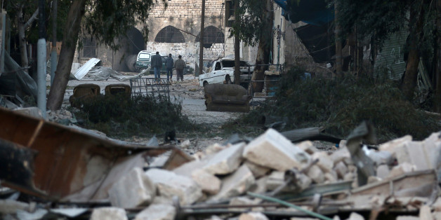 People walk near rubble of damaged buildings, in the rebel-held besieged area of Aleppo, Syria November 19, 2016. REUTERS/Abdalrhman Ismail