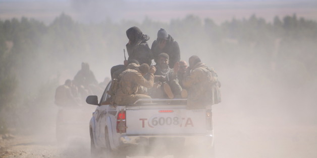 Democratic Forces of Syria fighters ride a pick-up truck near al-Shadadi town, Hasaka countryside Syria February 18, 2016. REUTERS/Rodi Said TPX IMAGES OF THE DAY