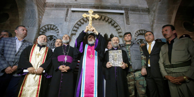 Iraqi Christians take part in a procession to erect a new cross over the Mar Korkeis church, after the original cross was destroyed by Islamic State militants, in the town of Bashiqa, Iraq, November 19, 2016. Picture taken November 19, 2016. REUTERS/Azad Lashkari