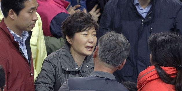 JINDO-GUN, SOUTH KOREA - APRIL 17: South Korean President Park Geun-Hye talks with relatives of missing passengers of a sunken ferry at Jindo gymnasium on April 17, 2014 in Jindo-gun, South Korea. Six are dead, and 290 are missing as reported. The ferry identified as the Sewol was carrying about 470 passengers, including the students and teachers, traveling to Jeju Island. (Photo by Chung Sung-Jun/Getty Images)