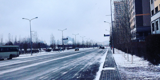 Snow Covered Street By Buildings Against Sky During Winter