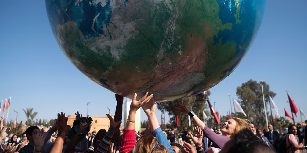Members of International delegations play with a giant air globe ball outside the COP22 climate conference on November 18, 2016, in Marrakesh. / AFP / FADEL SENNA (Photo credit should read FADEL SENNA/AFP/Getty Images)