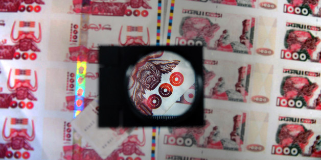 A picture taken on October 26, 2009 in Lyon, central France shows plates of false printed Algerian Dinar banknotes, shown during a press conference given after the police broke up a network of counterfeit currency. Twelve people were jailed and indicted on October 25, but the network has already used at least 200,000 banknotes of 1,000 dinars, or nearly 2 million Euros, said judicial police. AFP PHOTO PHILIPPE MERLE (Photo credit should read PHILIPPE MERLE/AFP/Getty Images)