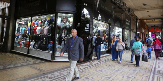 People walk past a clothes shop in Tunis, Tunisia, April 25, 2016. REUTERS/Zoubeir Souissi