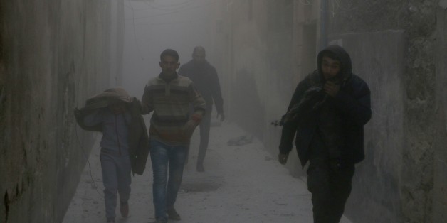 ALEPPO, SYRIA - NOVEMBER 21: Residents escape from the scene of the air strikes carried out by the war crafts belonging to the Syrian and Russian army over residential areas Firdevs Neighborhood of Aleppo, Syria on November 21, 2016. (Photo by Jawad al Rifai/Anadolu Agency/Getty Images)