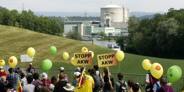 Protesters carry posters demanding a stop to nuclear power plants as they march in front of the power plant Beznau in the Swiss town of Doettingen, some 45 km (28 miles) northwest of Zurich May 22, 2011. Some 14,000 people took part in a demonstration against the use of nuclear energy. REUTERS/Arnd Wiegmann (SWITZERLAND - Tags: ENERGY ENVIRONMENT CIVIL UNREST)