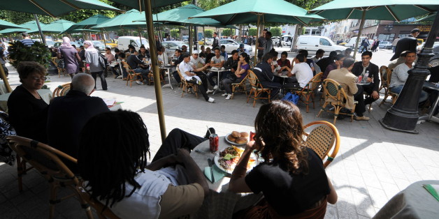 A Tunisians eat their lunch in Habib Bourguiba Avenue in Tunis's inner-city laneways which is home to many vibrant bars, cafes, retaurants, boutiques and shops as well as some of Tunis's best examples of street art and graffiti, on March 31, 2010 in Tunis. AFP PHOTO / FETHI BELAID (Photo credit should read FETHI BELAID/AFP/Getty Images)