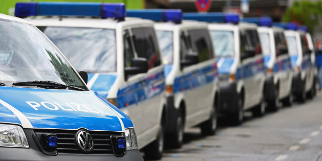 MUNICH, GERMANY - MAY 15: A fleet of police or Polizei vans are pictured parked near the fans of Bayern Muenchen as they celebrate winning the German Championship title on the town hall square at Marienplatz on May 15, 2016 in Munich, Germany. (Photo by Dean Mouhtaropoulos/Bongarts/Getty Images)