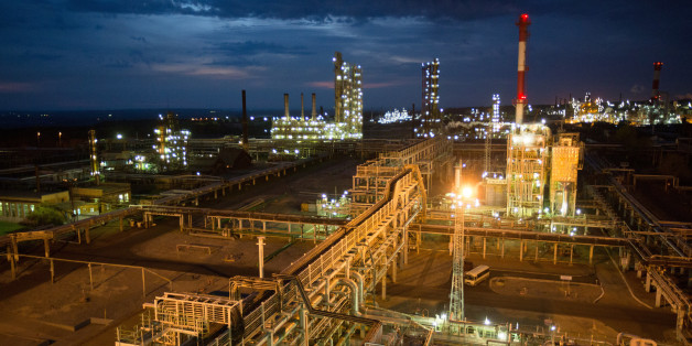 The sulphuric acid regeneration facility, right, sits illuminated by lights during evening operations at the Bashneft-Ufaneftekhim oil refinery, operated by Bashneft PAO, in Ufa, Russia, on Tuesday, Sept. 27, 2016. Bashneft distributes petroleum products and petrochemicals around the world and in Russia via filling stations. Photographer: Andrey Rudakov/Bloomberg via Getty Images