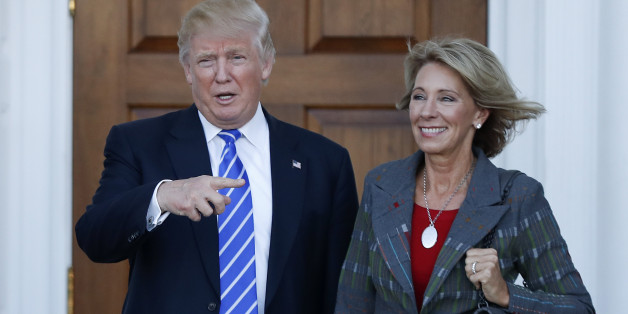 FILE - In this Nov. 19, 2016 file photo, President-elect Donald Trump and Betsy DeVos pose for photographs at Trump National Golf Club Bedminster clubhouse in Bedminster, N.J. Trump has chosen charter school advocate DeVos as Education Secretary in his administration. (AP Photo/Carolyn Kaster, File)