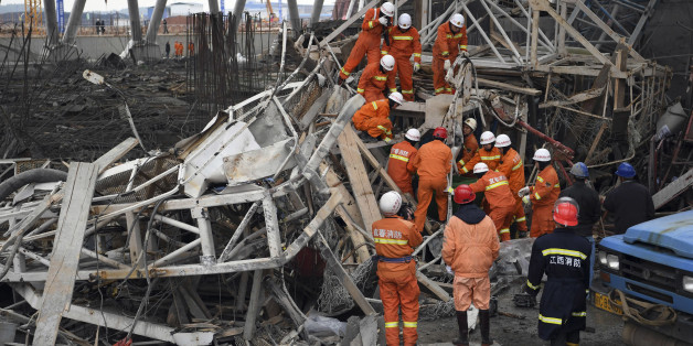 In this photo released by Xinhua News Agency, rescue workers look for survivors after a work platform collapsed at the Fengcheng power plant in eastern China's Jiangxi Province, Nov. 24, 2016. State media reported dozens were killed after the scaffolding tumbled down. (Wan Xiang/Xinhua via AP)