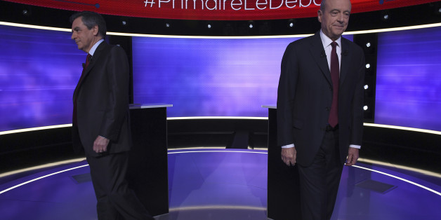 The two finalists for the right-wing Les Republicains (LR) party primaries ahead of the 2017 presidential election, Francois Fillon, left, and Alain Juppe, move after posing for photographs prior to taking part of a TV debate at French TV station TF1, in Boulogne-Billancourt, outside Paris Thursday Nov. 24, 2016. Former Prime Ministers Francois Fillon and Alain Juppe will meet in a runoff next Sunday for the nomination to be France's conservative candidate for president. (Eric Feferberg/ Pool Photo via AP)