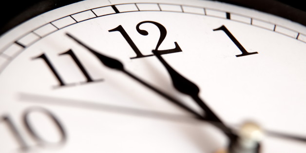 Closeup of hands on clock face