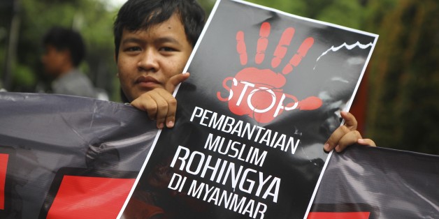 JAKARTA, INDONESIA - NOVEMBER 25 : An Indonesian Muslim activist carries a banner to protest violence and mass killings against Rohingya Muslims during a military crackdown in front of Myanmar Embaasy in Jakarta, Indonesia on November 25, 2016. (Photo by Agoes Rudianto /Anadolu Agency/Getty Images)