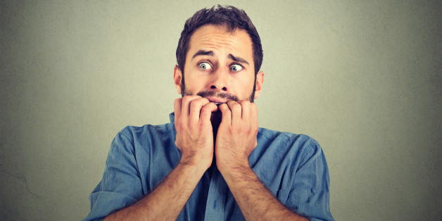 Portrait anxious young man biting his nails fingers freaking out