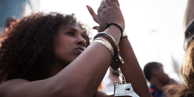 A demonstrator is wearing a handcuff, during a demonstration of Ethiopian Jews in Tel Aviv on May 3, 2015. A few thousands people marched through Tel Aviv in what was mostly a peaceful demonstration against police brutality directed against the Jewish Ethiopian community in Israel. During the early evening hours the demo turned violent as clashes broke between the protesters and the police, some 40 people were injured. (Photo by Omer Messinger/NurPhoto) (Photo by NurPhoto/NurPhoto via Getty Imag
