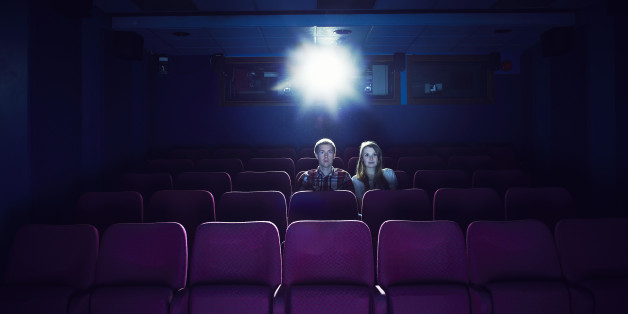 Couple watching a movie in an empty cinema
