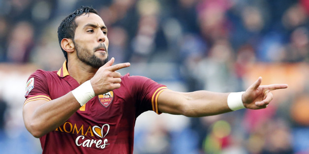 AS Roma's Mehdi Benatia celebrates after scoring against Genoa during their Serie A soccer match at Olympic stadium in Rome, January 12, 2014. REUTERS/Stefano Rellandini (ITALY - Tags: SPORT SOCCER)