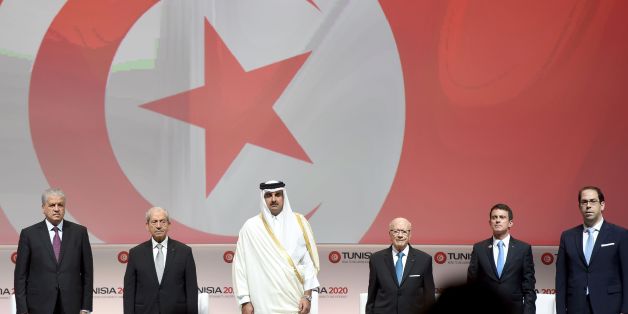 (LtoR) Algerian Prime Minister Abdelmalek Sellal: Tunisian Assembly President Mohamed Ennaceur; the Emir of Qatar, Tamim bin Hamad al-Thani; Tunisian President Beji Caid Essebsi, French Prime Minister Manuel Valls and Tunisian Prime Minister Youssef Chahed (R) stand on stage during the opening ceremony of the 'Tunisia 2020' international investment conference on November 29, 2016 in Tunis.
France and Qatar promised billions of dollars of financial support to Tunisia at the launch Tuesday of a conference aimed at reviving the country's struggling economy. Nearly six years after its Arab Spring revolution, Tunisia is hosting the conference in a bid to face down daunting economic challenges. / AFP / FETHI BELAID (Photo credit should read FETHI BELAID/AFP/Getty Images)