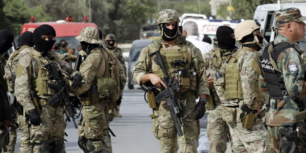 Tunisian security forces are seen after a raid on a house where gunmen were holed up in Oued Ellil, west of Tunis October 24, 2014. Tunisian security forces on Friday killed six people, including five women, after a standoff with an Islamist militant group on the outskirts of Tunis two days before a parliamentary election, authorities said. REUTERS/Anis Mili (TUNISIA - Tags: POLITICS CIVIL UNREST MILITARY)