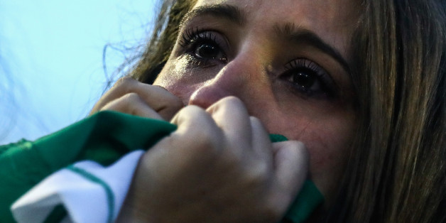 CHAPECO, BRAZIL - NOVEMBER 30: A fan cries while paying tribute to the players of Brazilian team Chapecoense Real at the club's Arena Conda stadium in Chapeco, in the southern Brazilian state of Santa Catarina, on November 30, 2016. The players were killed in a plane accident in the Colombian mountains. Players of the Chapecoense team were among the 77 people on board the doomed flight that crashed into mountains in northwestern Colombia. Officials said just six people were thought to have surv