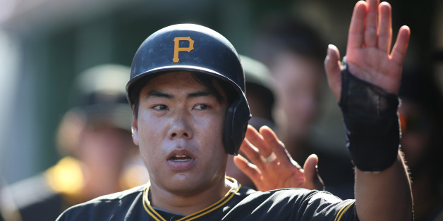 May 23, 2015; Pittsburgh, PA, USA; Pittsburgh Pirates shortstop Jung Ho Kang (27) celebrates in the dugout after scoring a run against the New York Mets during the fourth inning at PNC Park. Mandatory Credit: Charles LeClaire-USA TODAY Sports