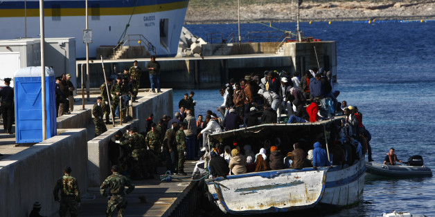 A wooden boat packed with African immigrants, fleeing the unrest in Libya, berths at a jetty in Cirkewwa in the north of Malta March 29, 2011. A total of 281 immigrants from Eritrea, Ethiopia and Sudan arrived in Malta on Tuesday. Malta has appealed to the international community for assistance in dealing with the current influx of illegal immigrants. In an appeal during a London meeting for international powers to discuss Libya, Maltese Foreign Minister Tonio Borg said that the international