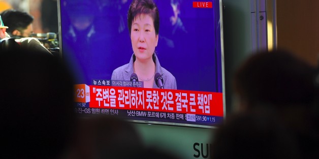People watch a television news live showing South Korean President Park Geun-Hye making a speech, at a railway station in Seoul on November 29, 2016.South Korea's scandal-hit President Park Geun-Hye said on November 29 she was willing to leave office before the end of her official term early 2018 and would let parliament decide on her fate. / AFP / JUNG Yeon-Je (Photo credit should read JUNG YEON-JE/AFP/Getty Images)